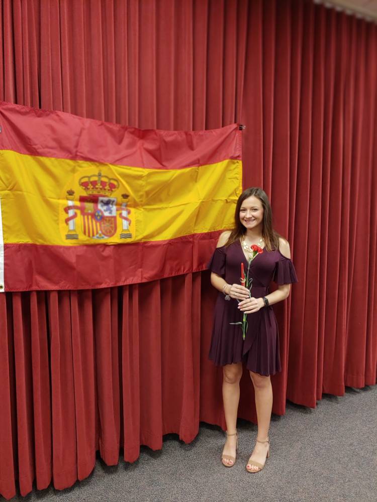 Riley Burgess posing in front of Spanish flag